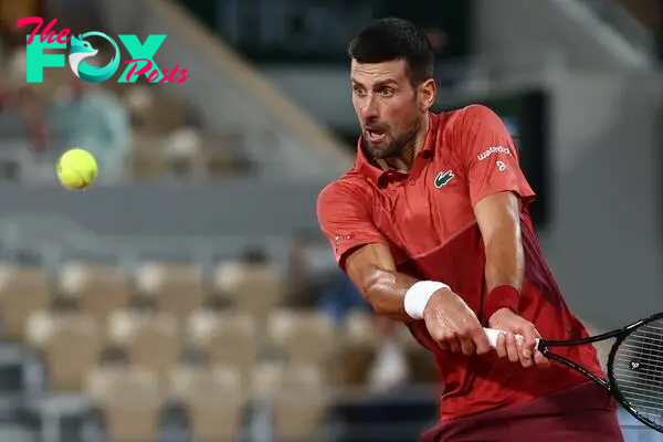 Serbia's Novak Djokovic plays a backhand return to Italy's Lorenzo Musetti during their men's singles match on Court Philippe-Chatrier on day seven of the French Open tennis tournament at the Roland Garros Complex in Paris on June 2, 2024. (Photo by Emmanuel Dunand / AFP)