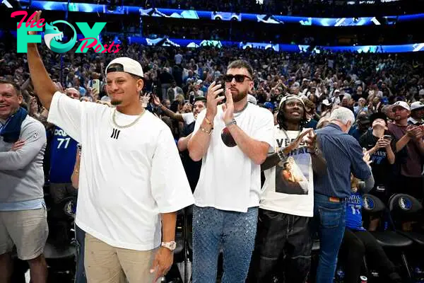 Kansas City Chiefs quarterback Patrick Mahomes (left) and tight end Travis Kelce (center) and Hollywood Brown (right) celebrate after game three between the Dallas Mavericks and the Minnesota Timberwolves in the Western Conference finals for the 2024 NBA playoffs at American Airlines Center.