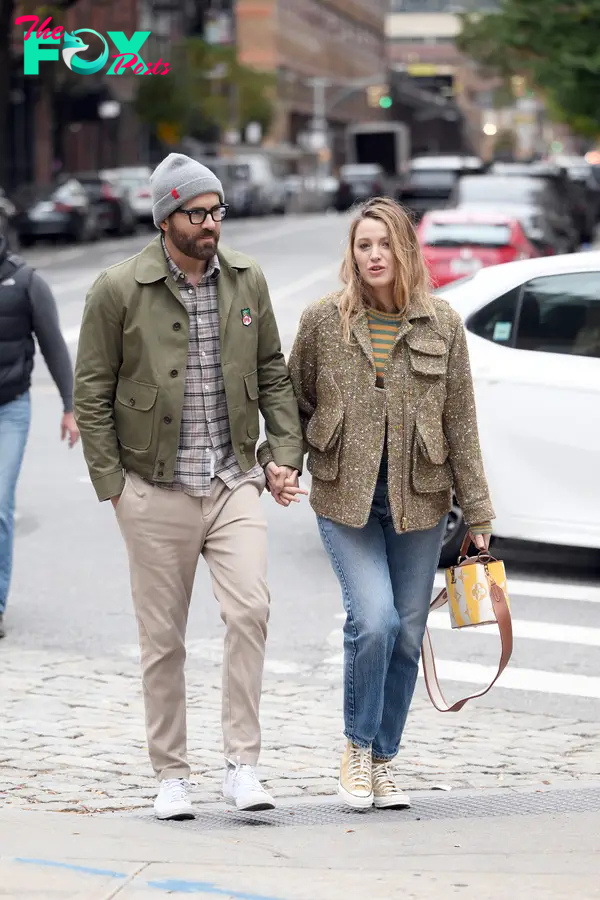 Blake Lively and Ryan Reynolds holding hands while out for a morning walk in New York City.