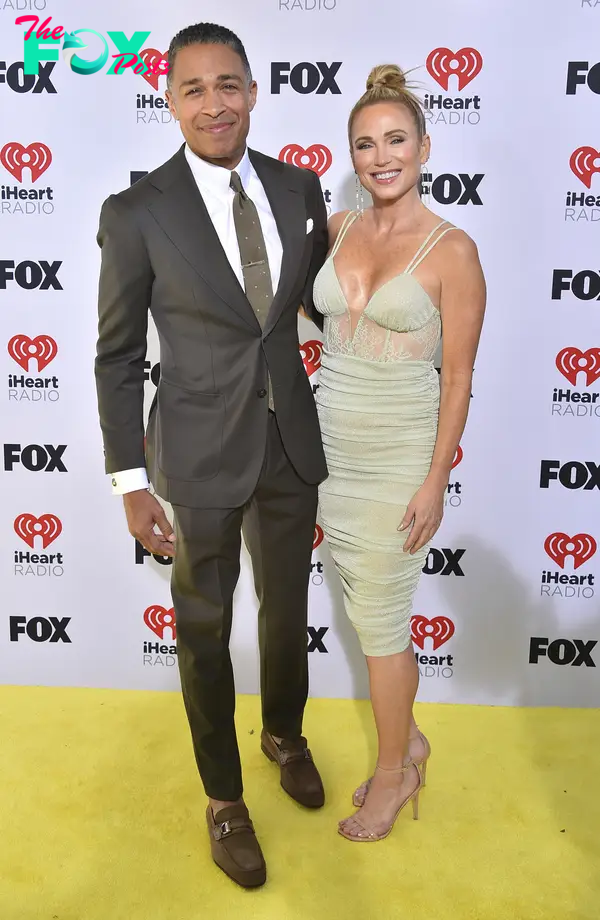 T.J. Holmes and Amy Robach posing on a red carpet