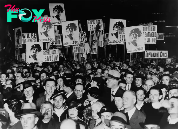 A crowd in Milan watches a broadcast of Mussolini announcing the creation of an Italian empire on March 12, 1936.