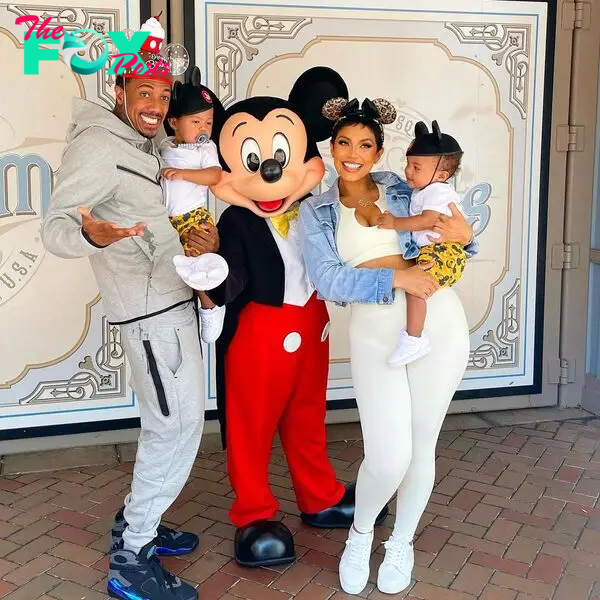 Nick Cannon and Abby De La Rosa with their kids and MIckey Mouse.