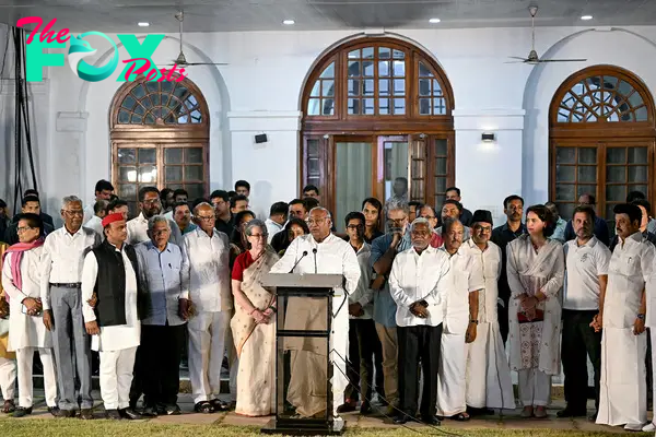 Mallikarjun Kharge, President of Indian National Congress party, addresses the gathering after a meeting of opposition alliance Indian National Developmental Inclusive Alliance (INDIA) bloc, as INC leaders Sonia Gandhi, center left, and son Rahul Gandhi, second from right, look on at his residence in New Delhi on June 5, 2024, on the following day of voting results for India's general election.