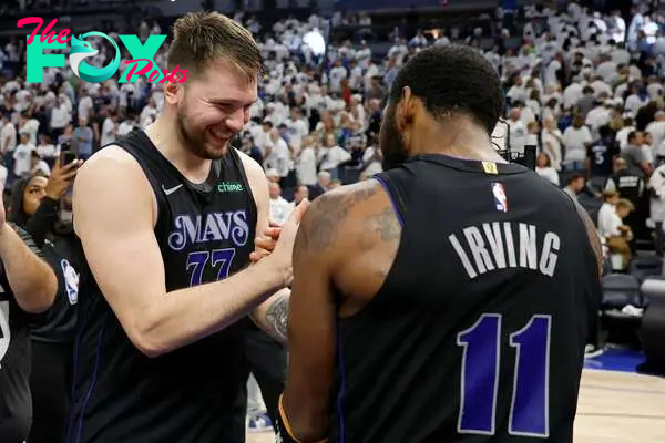 Luka Doncic #77 celebrates with Kyrie Irving #11of the Dallas Mavericks 