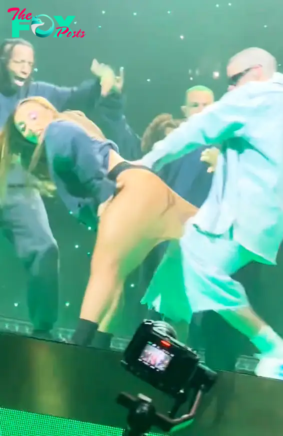 Bad Bunny performing with a dancer.