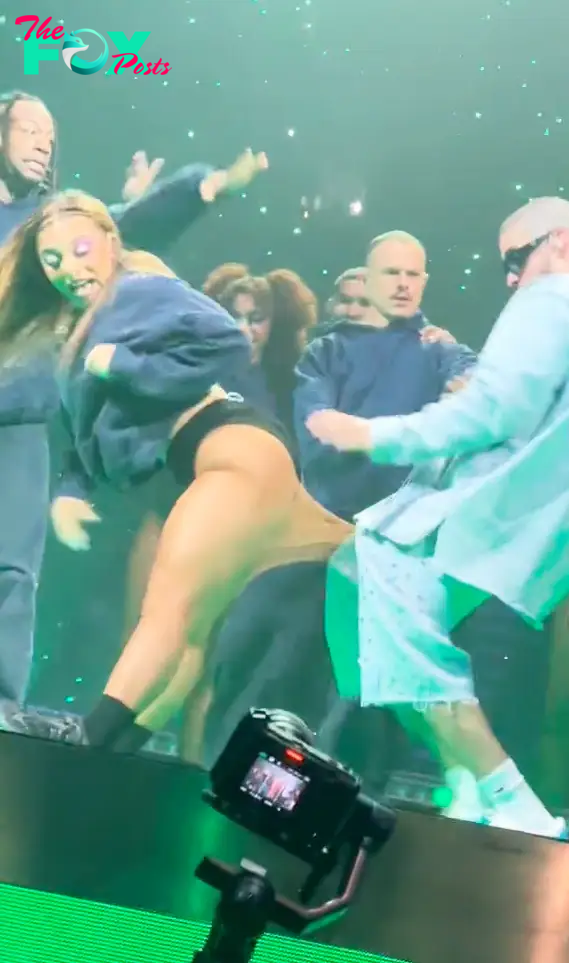 Bad Bunny performing with a dancer.