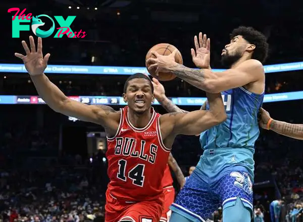 Nick Richards #14 of the Charlotte Hornets battles Malcolm Hill #14 of the Chicago Bulls for a rebound during the first half of their game at Spectrum Center on February 09, 2022 in Charlotte, North Carolina. 