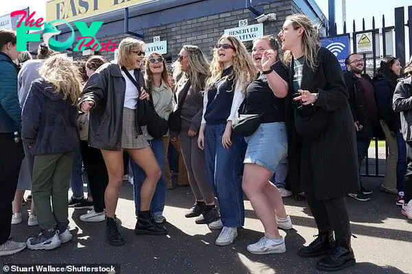 Fans sing and dance as they queue for VIP Taylor Swift merchandise today