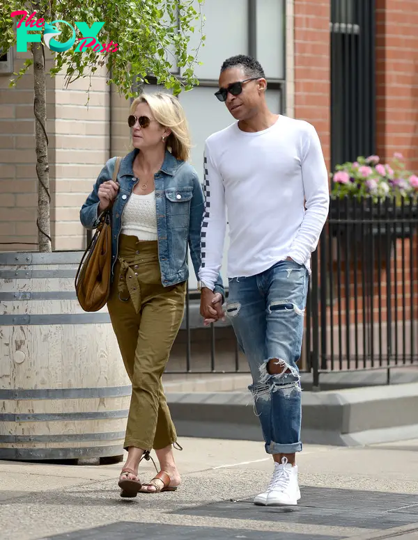 Amy Robach and TJ Holmes walking together 