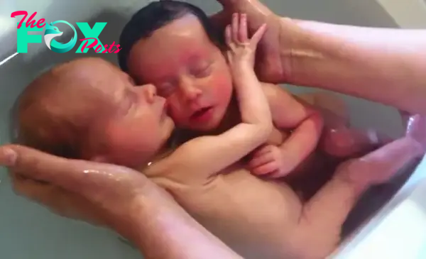Twins mimic life in the womb in amazing baby bath video
