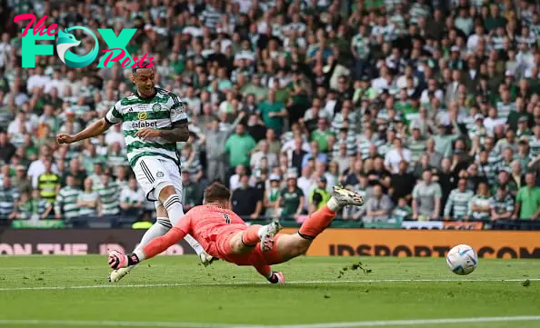 Adam Idah of Celtic scores his team's first goal past Jack Butland of Rangers during the Scottish Cup Final match between Celtic and Rangers at Ham...