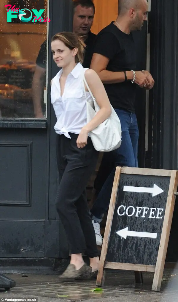 Effortlessly elegant: Emma Watson meets a friend for a coffee in central London wearing a tie top and black slacks