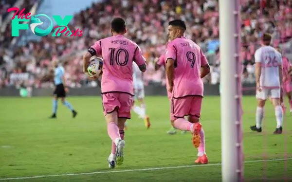 Inter Miami's Argentine forward #10 Lionel Messi picks up the ball after scoring next to Inter Miami's Uruguayan forward #09 Luis Suarez during the Major League Soccer (MLS) regular season football match between Inter Miami CF and St. Louis CITY SC at Chase Stadium in Fort Lauderdale, Florida in June 1, 2024. (Photo by Chris ARJOON / AFP)