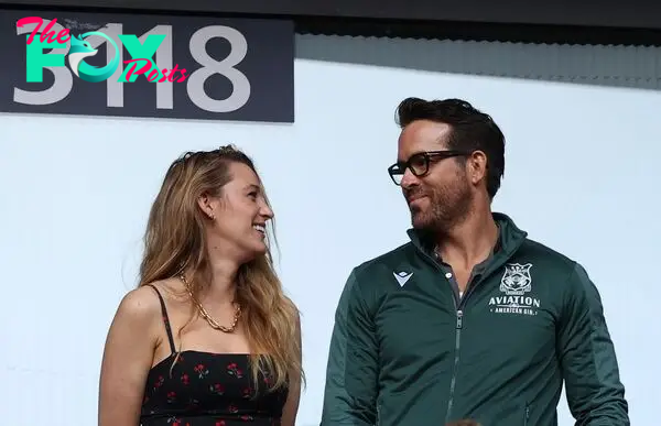 Blake Lively and Ryan Reynolds gazing at each other at a Wrexham game