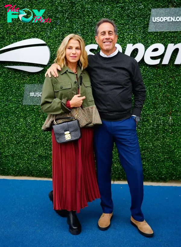 Jerry Seinfeld and Jessica Seinfeld smiling on a red carpet. 