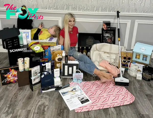 Tori Spelling sitting with household items