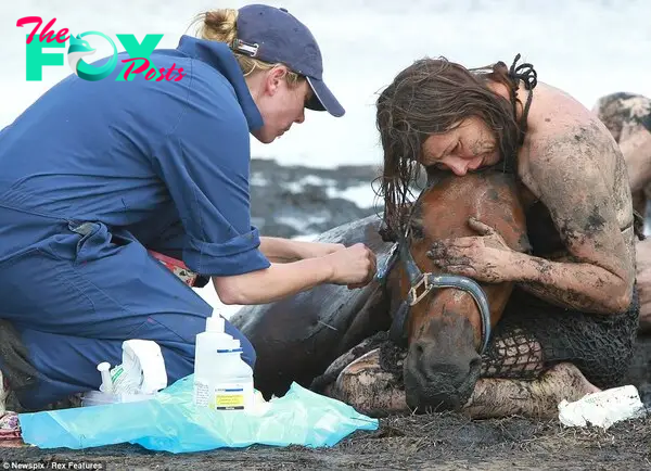 Tidal terror: The brave mother tries to keep the horse calm as rescuers work how out to free the animal