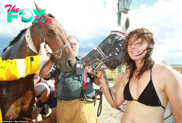 It's all over: Miss Graham leads her horses away from the beach after the traumatic rescue