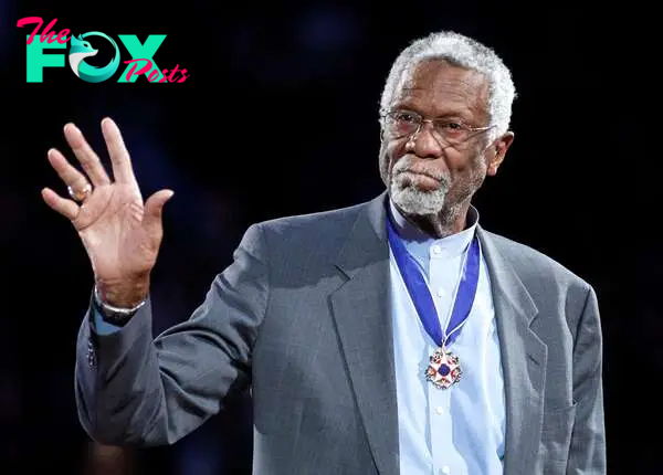 FILE PHOTO: Boston Celtics' great Bill Russell stands with his Presidential Medal of Freedom during the NBA All-Star basketball game in Los Angeles, February 20, 2011.  REUTERS/Danny Moloshok/File Photo