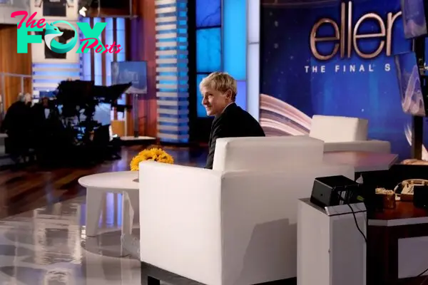 Ellen DeGeneres looks sad on her final show, sitting in a white chair.