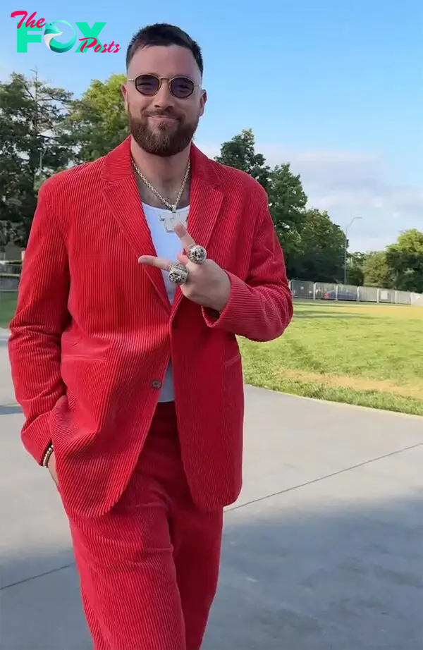 Travis Kelce wearing a red suit at the Chiefs Super Bowl ring ceremony