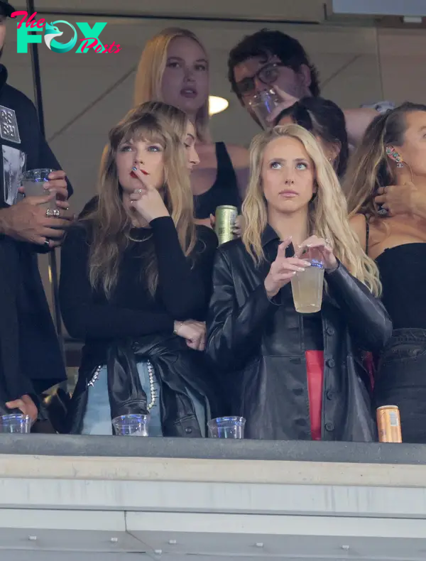 Artist Taylor Swift reacts along side Kansas City Chiefs quarterback Patrick Mahomes wife Brittany in a luxury box with a drink in her hand in the 2nd quarter.