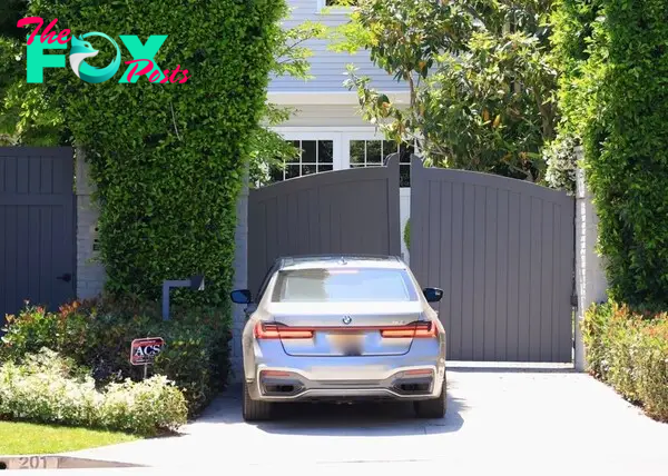 Jennifer Lopez in a car pulling up to Ben Affleck's Brentwood rental house. 