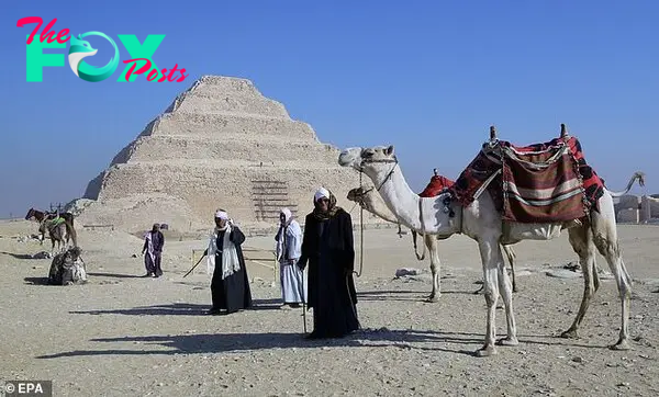 Egyptian camel owners wait for tourists at King Djoser's step pyramid, also known as the Saqqara pyramid in Saqqara area of Giza