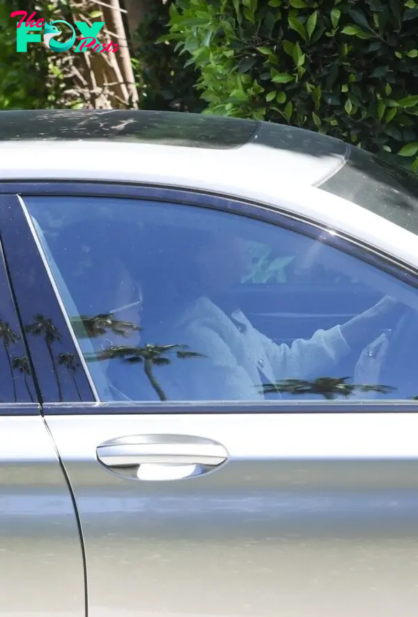 Jennifer Lopez in the passenger seat of a car