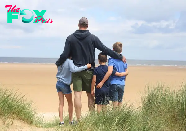 Prince William with his three kids at the beach.