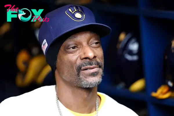 Snoop Dogg has been regularly spotted at sporting events and threw the first pitch before the MLB game between the Milwaukee Brewers vs Cincinnati Reds on Saturday. 