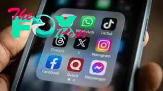 A cell phone with icons for many social media apps