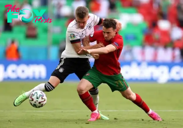 MUNICH, GERMANY - JUNE 19: Diogo Jota of Portugal holds off Matthias Ginter of Germany during the UEFA Euro 2020 Championship Group F match between Portugal and Germany at Football Arena Munich on June 19, 2021 in Munich, Germany. (Photo by Alex Grimm - UEFA/UEFA via Getty Images)