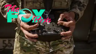 A soldier holding a drone