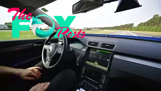 A person sitting in a self-driving car