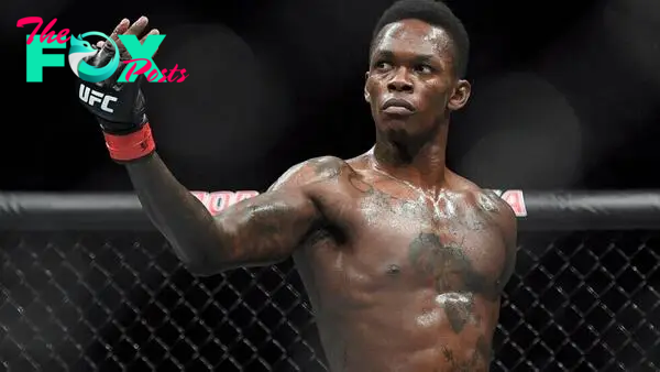 FILE - In this Feb. 10, 2019, file photo, Nigeria's Israel Adesanya poses as he fights Brazil's Anderson Silva in their middleweight bout at the UFC 234 mixed martial arts fights in Melbourne, Australia. Adesanya challenges champion Jan Blachowicz of Poland for the light heavyweight title in the main event of UFC 259 on Saturday in Las Vegas.  (AP Photo/Andy Brownbill, File)