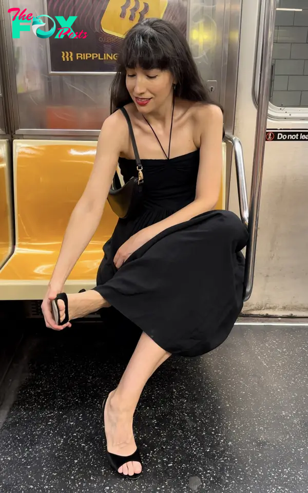 A woman sitting on the subway