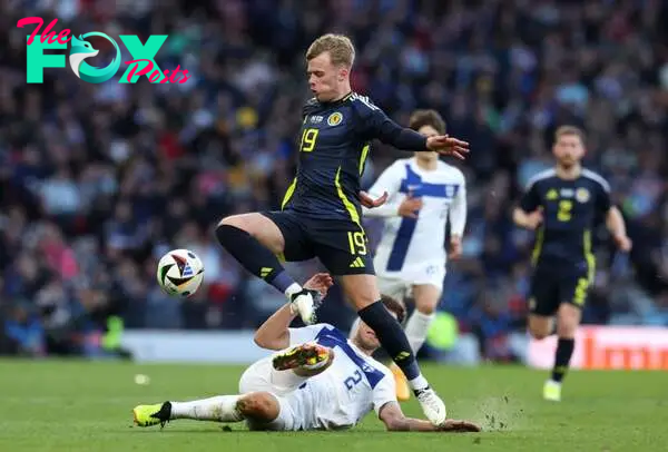 Tommy Conway of Scotland is challenged by Leo Vaisanen of Fnland during the international friendly match between Scotland and Finland at Hampden Pa...