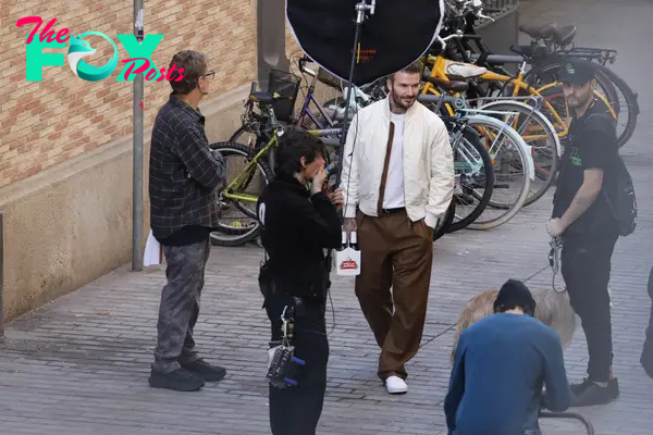 The former footballer was filming a commercial for the beer brand in the winter sunshine