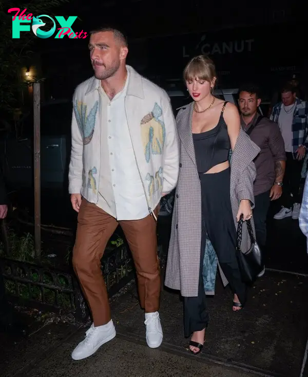 Travis Kelce and Taylor Swift holding hands. 