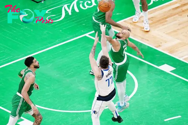 Jun 17, 2024; Boston, Massachusetts, USA; Dallas Mavericks guard Luka Doncic (77) shoots against Boston Celtics guard Derrick White (9) in the third quarter during game five of the 2024 NBA Finals at TD Garden. Mandatory Credit: David Butler II-USA TODAY Sports