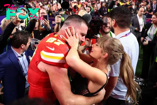 Travis Kelce and Taylor Swift  on the football field. 