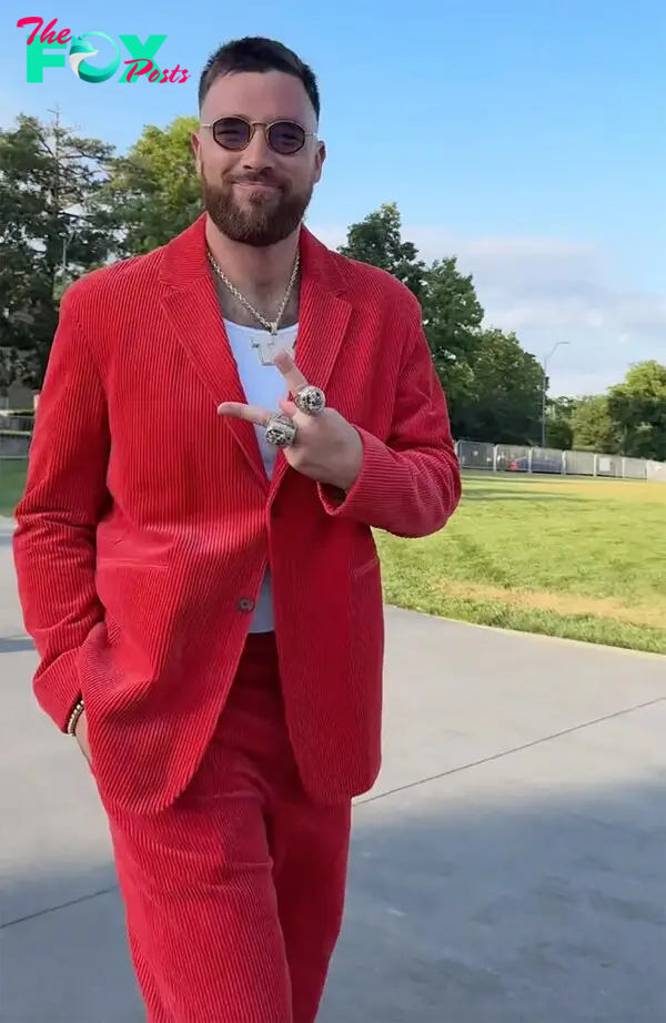 Travis Kelce throwing up a peace sign. 