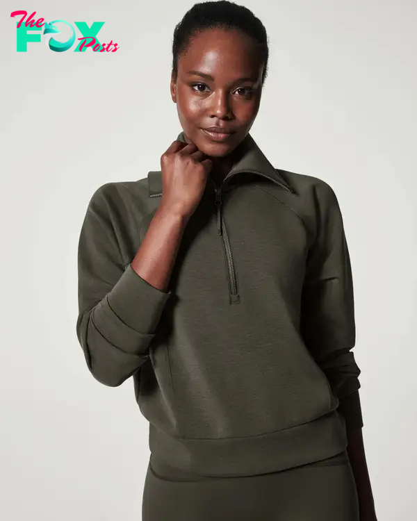 A model in a half zip sweatshirt