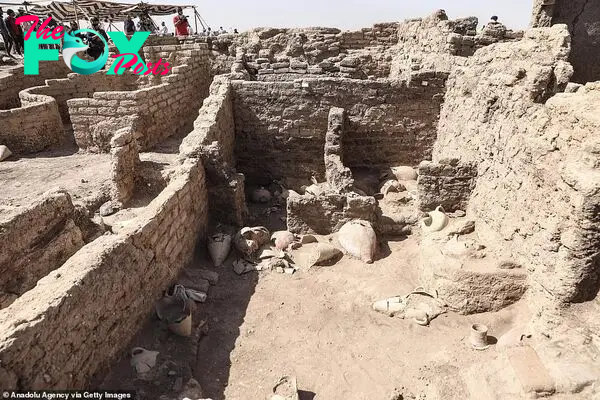 An intact room inside the ancient city is filled with pottery, much of it still buried in sand, but incredibly intact for its age