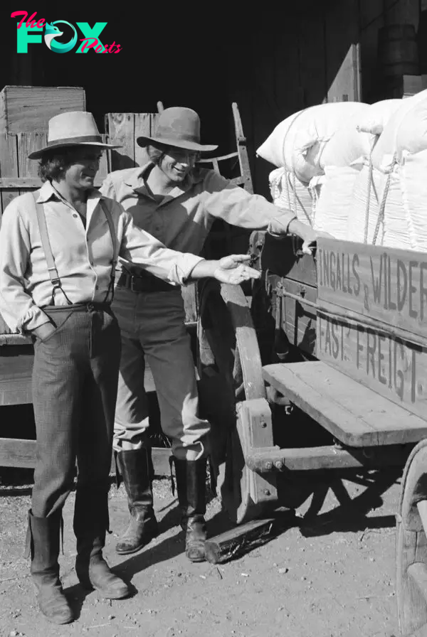 Michael Landon and Dean Butler stand and admire a wagon on "Little House on the Prairie."