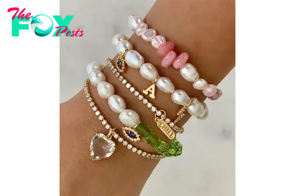 An arm with a stack of bracelets on it