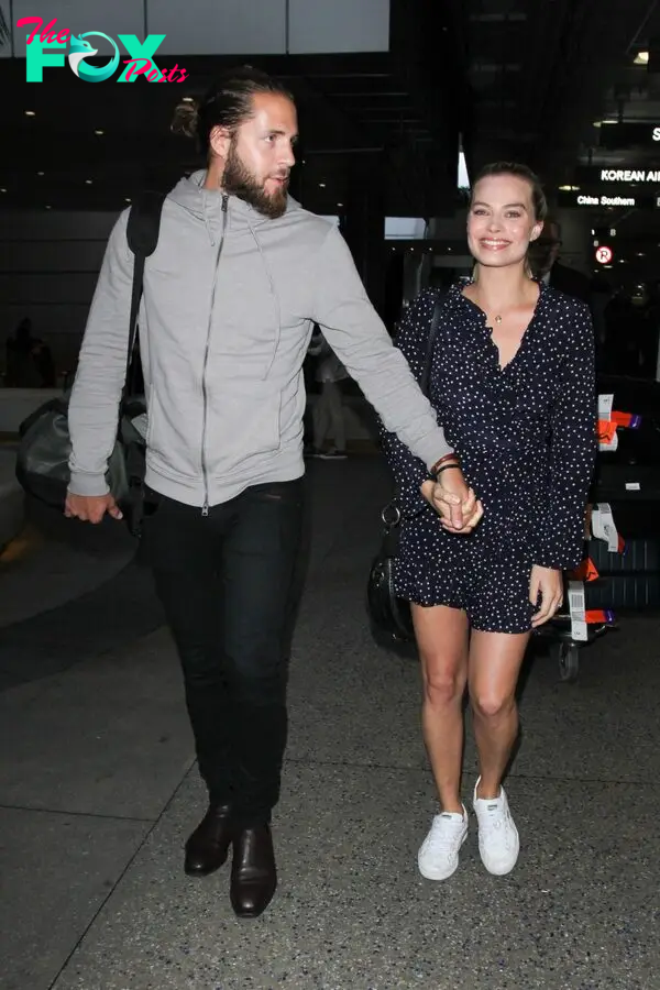 Margot Robbie and Tom Ackerley are seen at LAX in 2017.