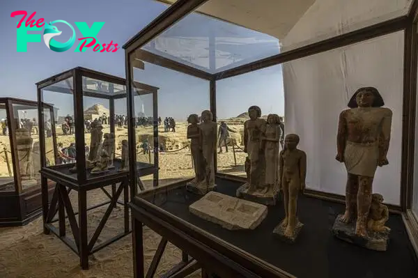 A collection of pharaoh statues is on display during a press conference at the Saqqara necropolis.