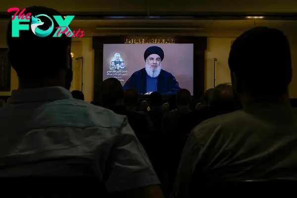 Hezbollah supporters watch a speech given by Hezbollah leader Hassan Nasrallah on June 19 during a ceremony to commemorate the death of senior commander Taleb Sami Abdullah, 55, who was killed by an Israeli strike in south Lebanon.